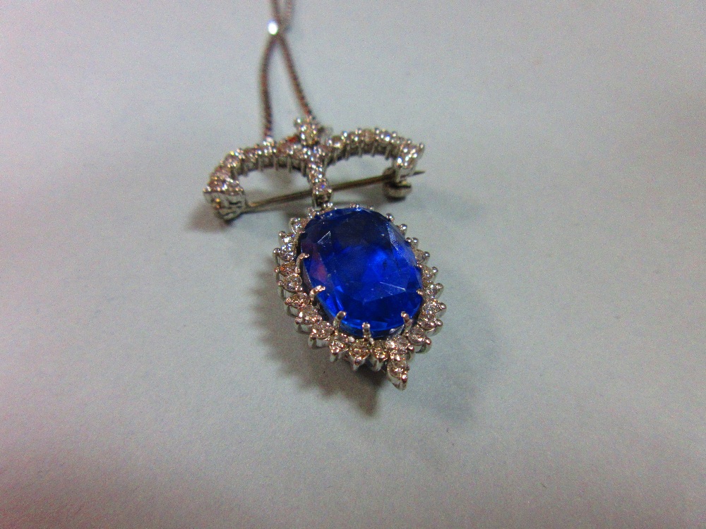 A sapphire and diamond pendant / brooch with white gold chain, the jewel designed as a large oval - Image 4 of 5