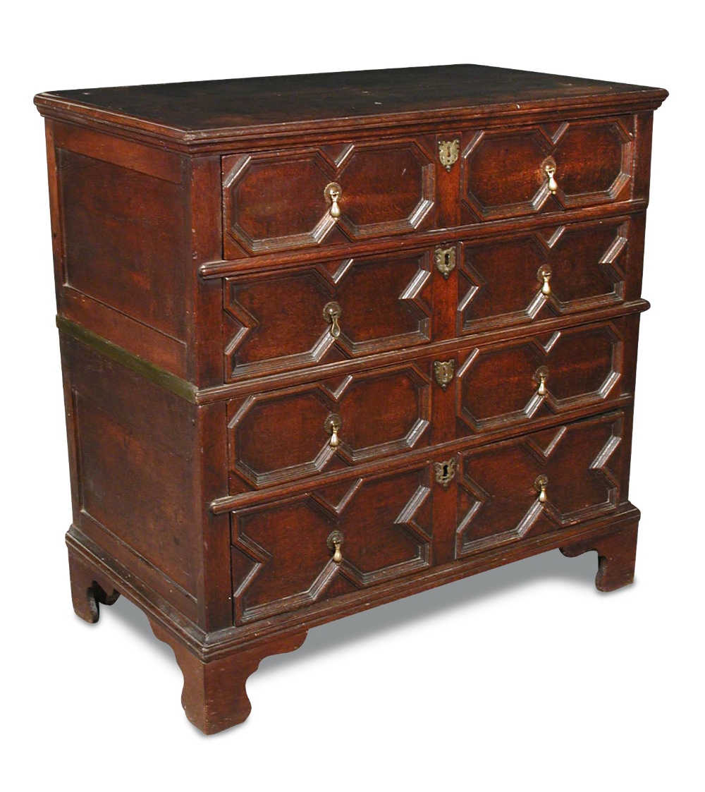 A James II oak chest, with moulded drawer fronts in two halves, brass pear drop handles and brass