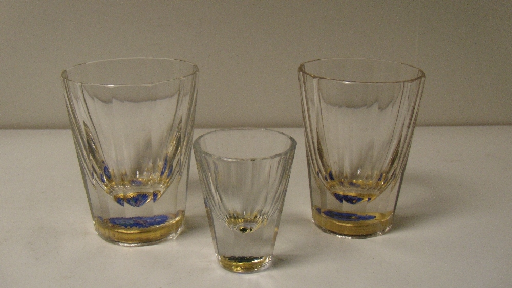 Three 19th century zwischengold tumblers, each with tapering facetted sides, the feet inset with - Image 2 of 2