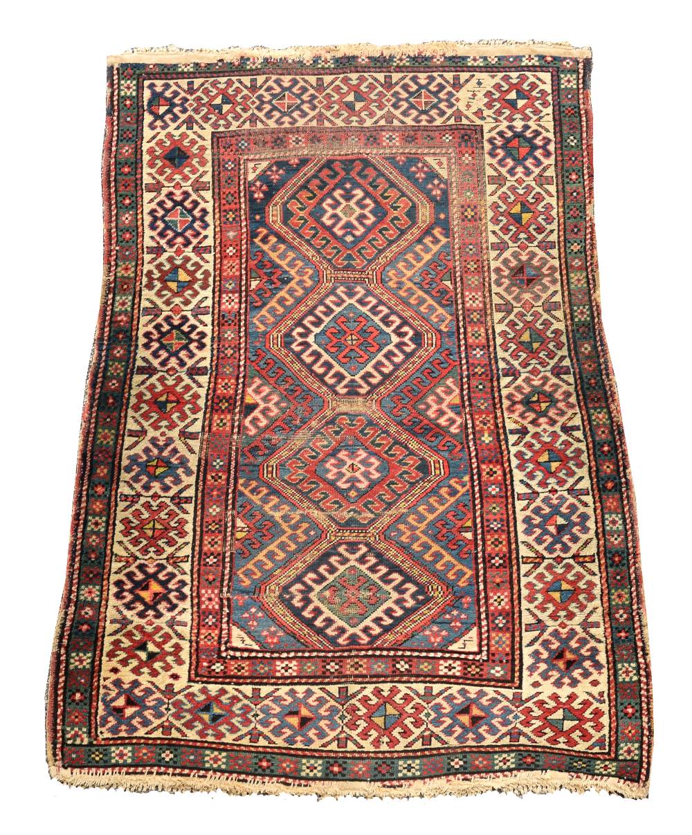 A Caucasian rug, 187 x 113cm (73 x 44in) Worn with low pile, ridging, border losses and binding