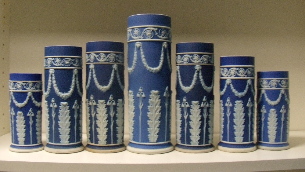 A garniture of seven early 20th century Wedgwood blue jasper spill vases, each with floral swags