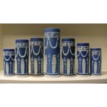 A garniture of seven early 20th century Wedgwood blue jasper spill vases, each with floral swags