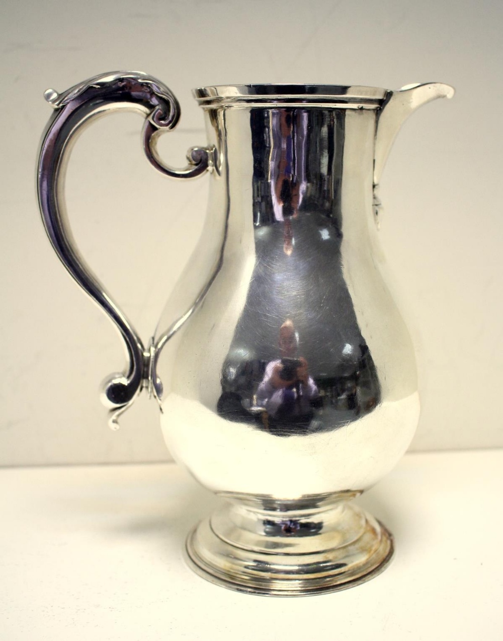 A George II silver ale jug, by Thomas Whipham, London 1775, of plain baluster shape, with leaf - Image 2 of 5