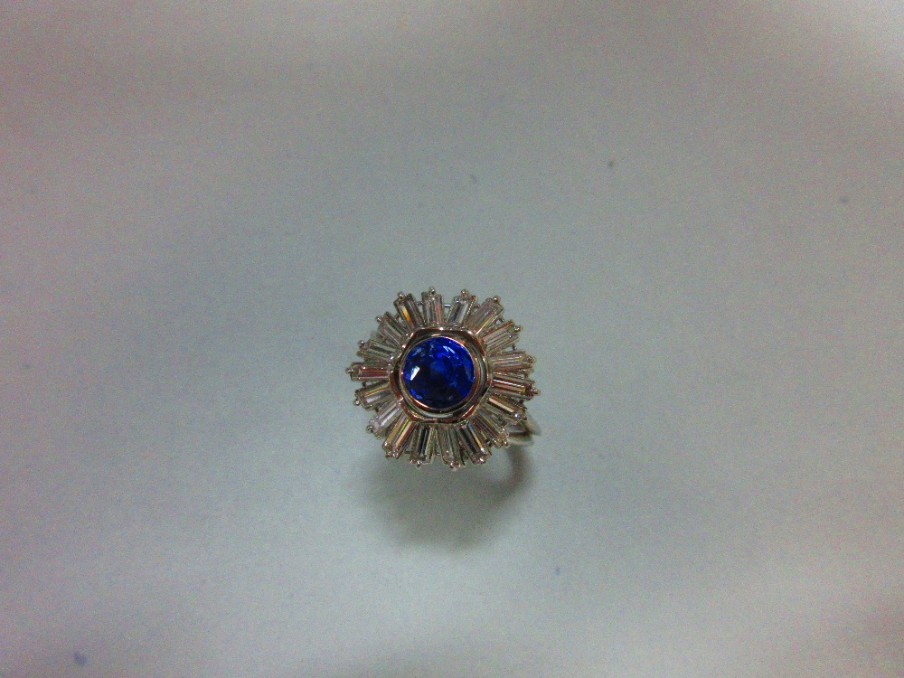 A sapphire and diamond sunburst cluster ring, the round cut light indigo coloured sapphire collet - Image 5 of 5