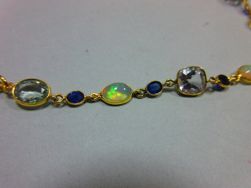 An 18ct gold opal, sapphire and aquamarine necklace, set to the front with an articulated line of - Image 4 of 4