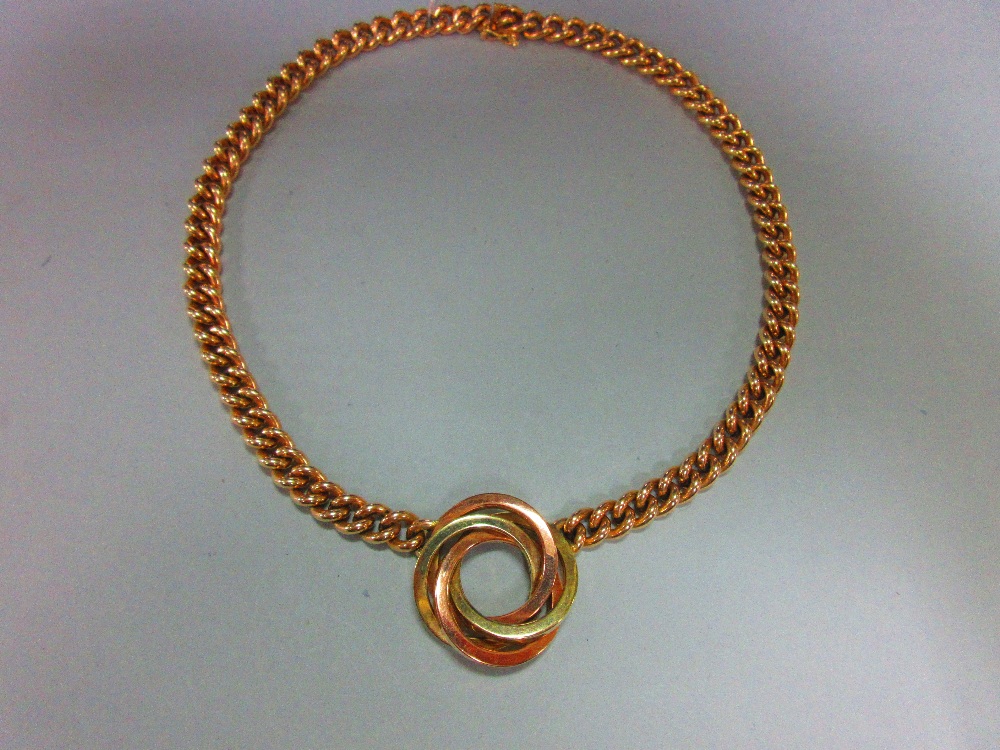 A curb link chain necklace with central knot feature, the knot composed of three square section