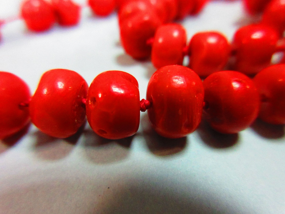 A long red coral bead necklace, the individually-knotted tyre shaped coral beads of approximately - Image 5 of 5