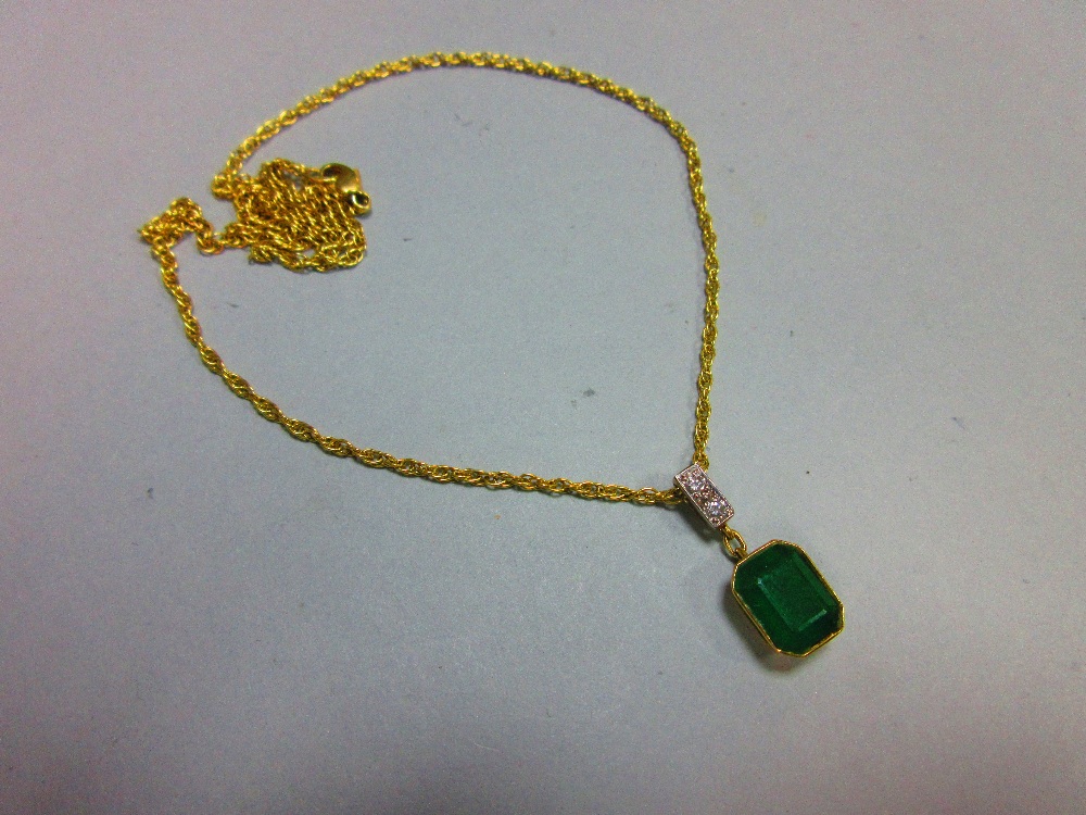 An emerald and diamond pendant set in 18ct gold, with chain, the emerald cut emerald collet set - Image 2 of 5