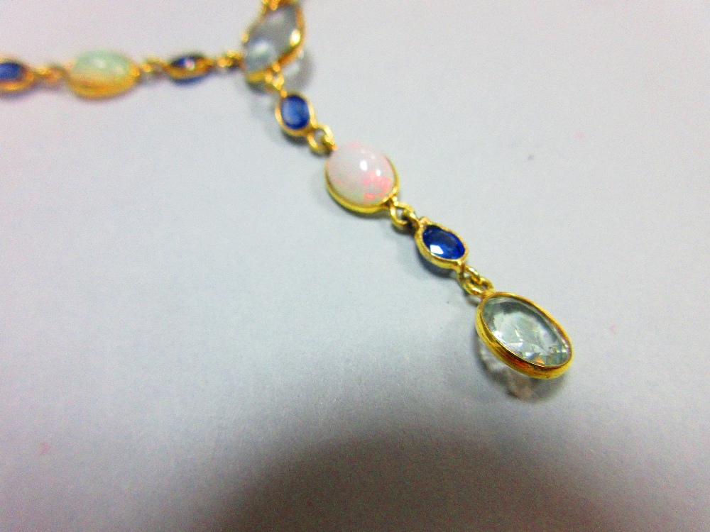 An 18ct gold opal, sapphire and aquamarine necklace, set to the front with an articulated line of - Image 2 of 4