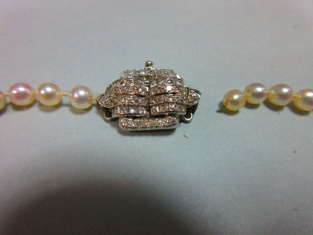 A pearl necklace with art deco diamond clasp, the individually knotted string of graduated 3.8-5.2mm - Image 2 of 5