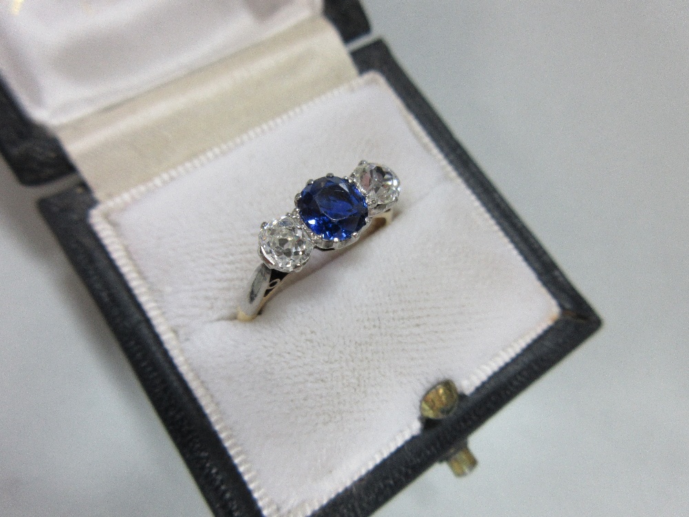 A three stone sapphire and diamond ring, claw set with a round cut royal blue sapphire between old - Image 7 of 7