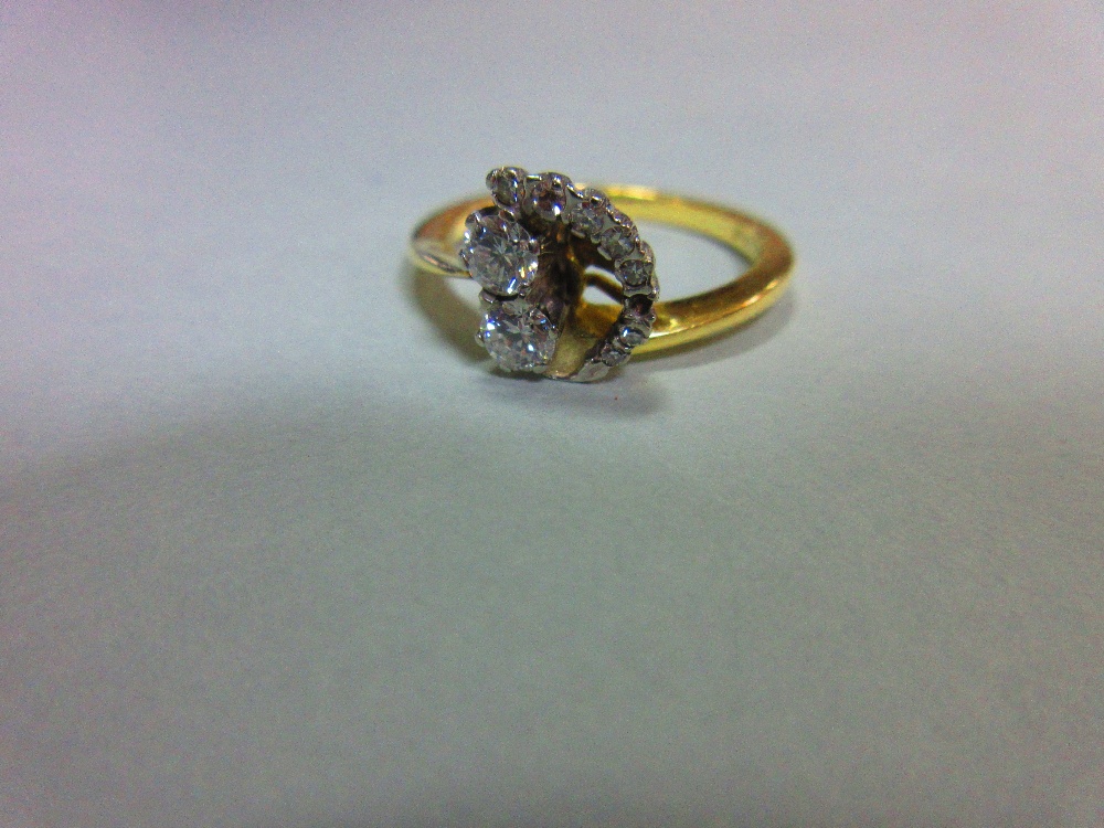 An asymmetric diamond ring set in 18ct gold, designed with two principal round brilliant cut - Image 4 of 5