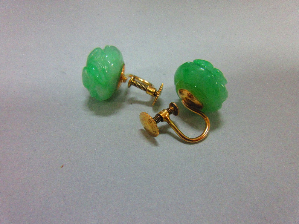 A pair of carved jadeite jade screwback earrings, each bouton of light emerald green mottled jade - Image 2 of 3