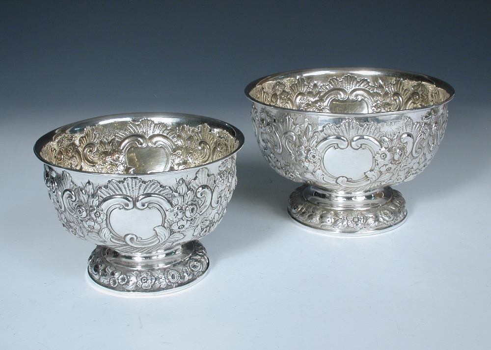 A small matched graduated pair of Edwardian silver rose bowls, one by Charles Stuart Harris,