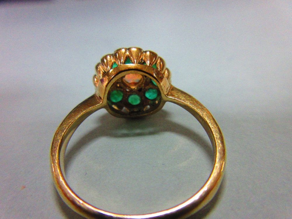 An opal and emerald cluster ring, with a round cabochon opal centre in a border of eight round cut - Image 4 of 4