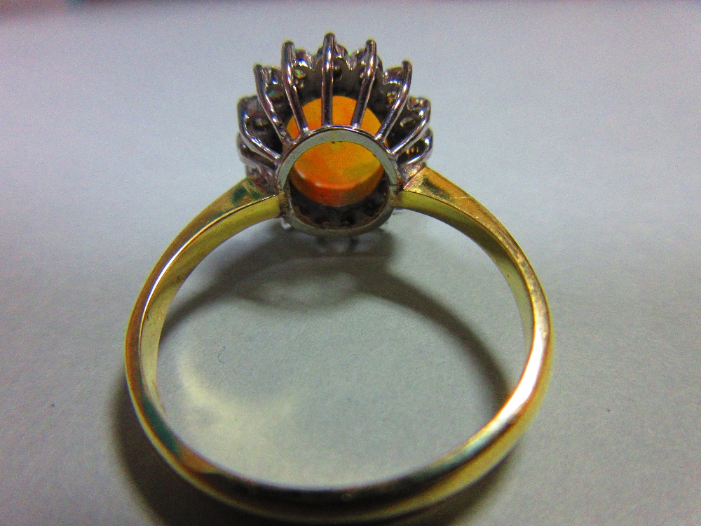 An opal and diamond cluster ring, the oval cabochon opal, displaying vivid predominently green and - Image 5 of 6