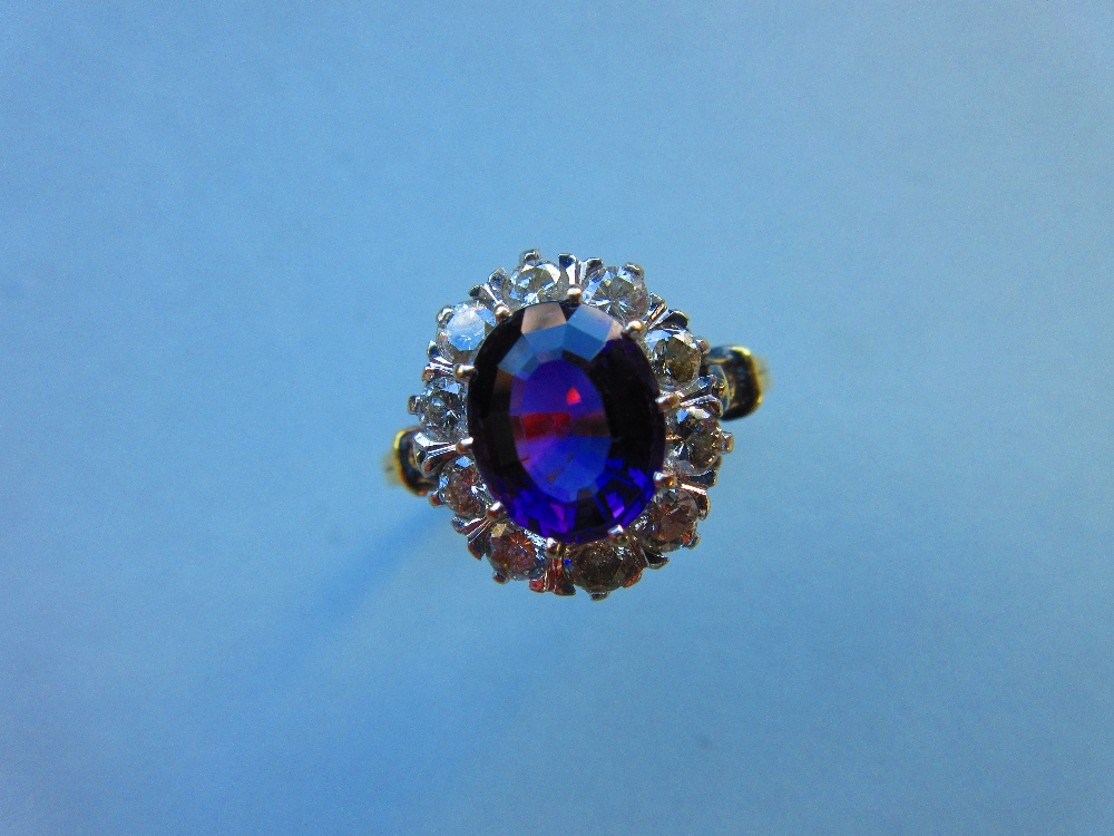 An amethyst and diamond cluster ring, the oval mixed cut rich purple amethyst claw set in a border - Image 8 of 8