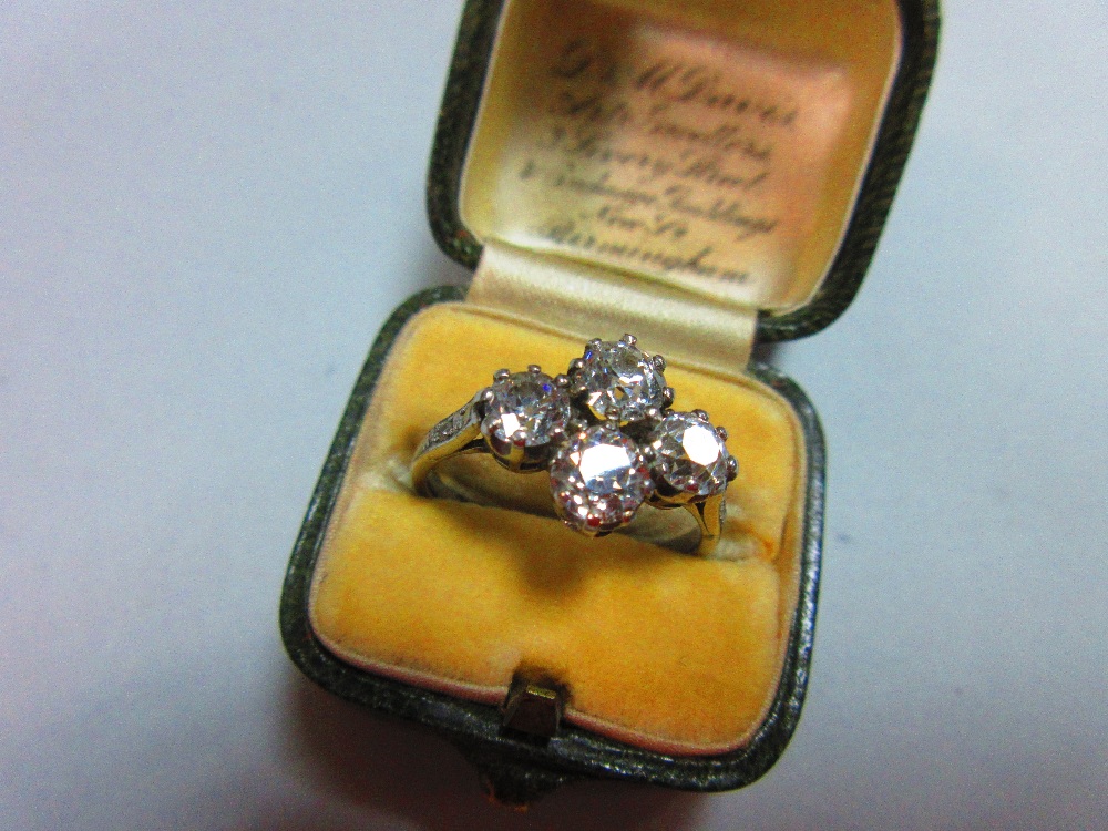 An unusual four stone diamond ring, the old round brilliant cut diamonds claw set in a horizontal - Image 7 of 7