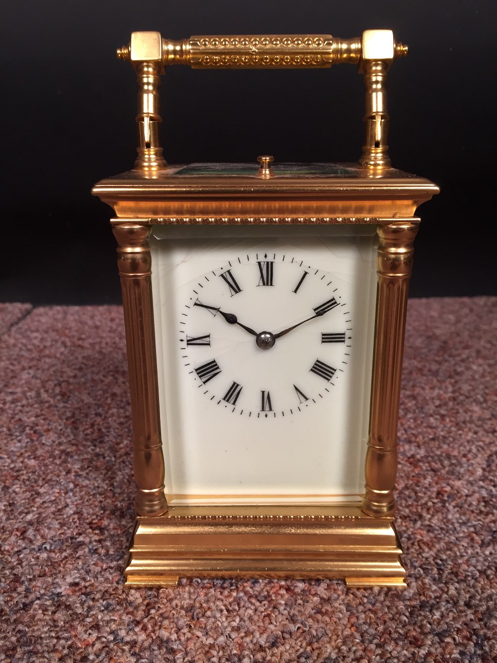 A French gilt brass carriage clock with repeat, the pillared case with silvered platform lever