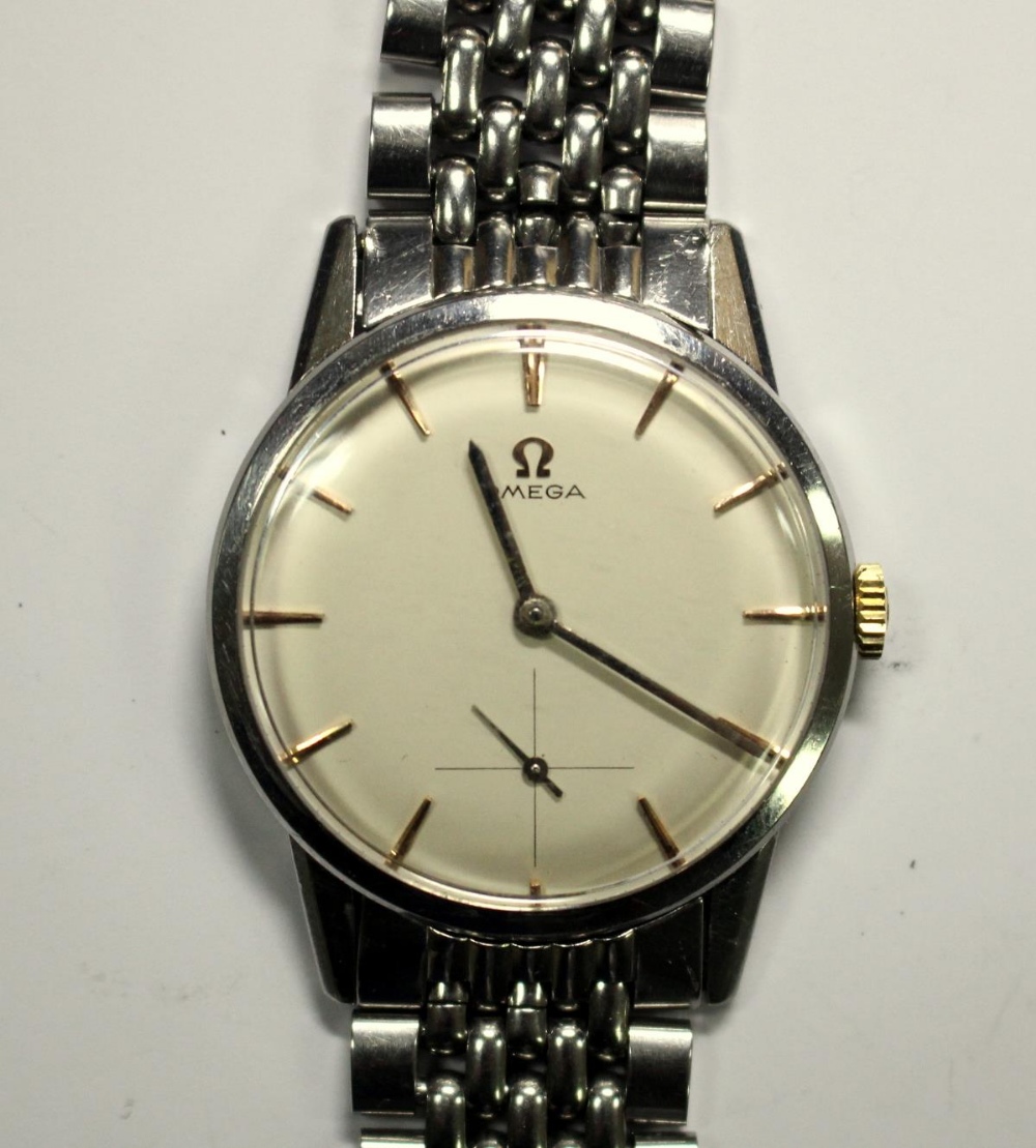 By Omega - a gentleman's steel cased manual wind wristwatch, circa 1960's, champagne coloured dial