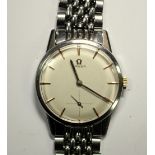 By Omega - a gentleman's steel cased manual wind wristwatch, circa 1960's, champagne coloured dial