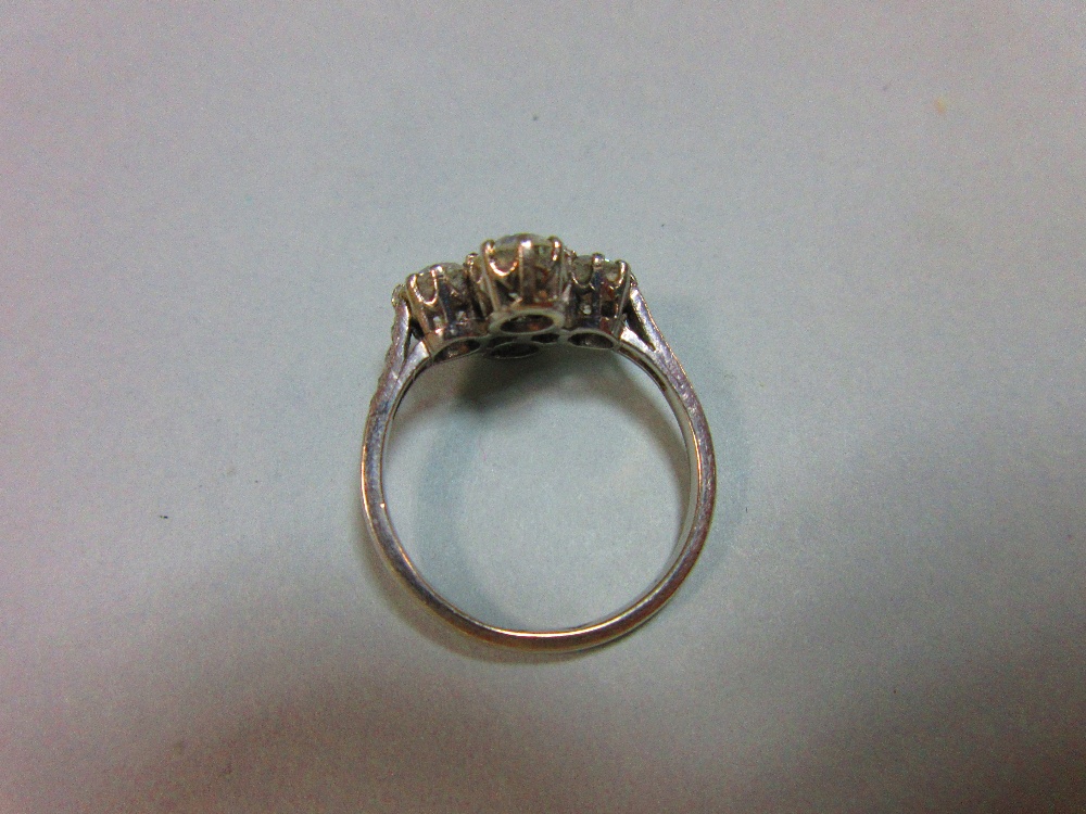 An unusual four stone diamond ring, the old round brilliant cut diamonds claw set in a horizontal - Image 5 of 7