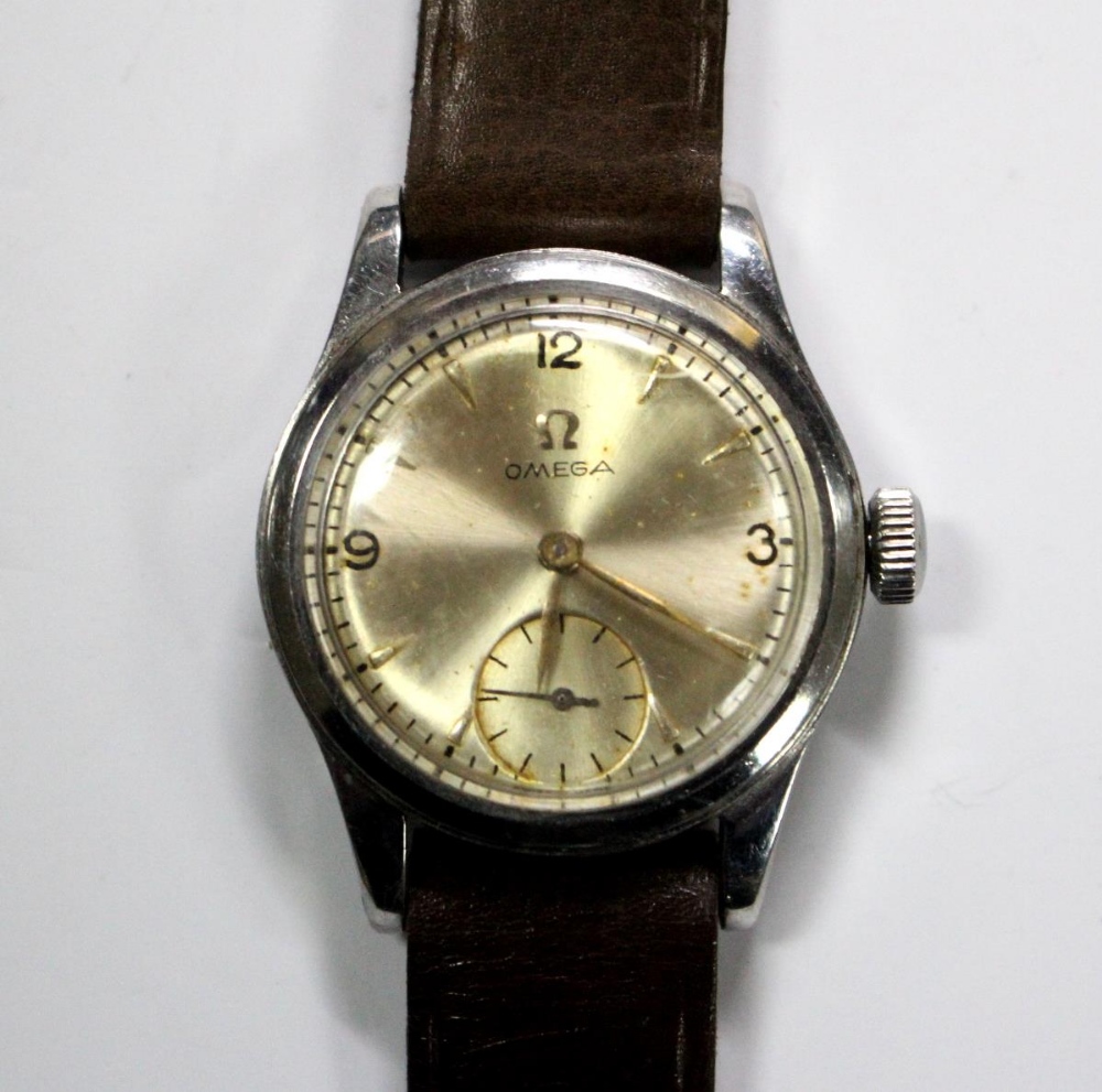 By Omega - a gentleman's mid-sized steel cased wrist watch, circa 1940's, the champagne coloured