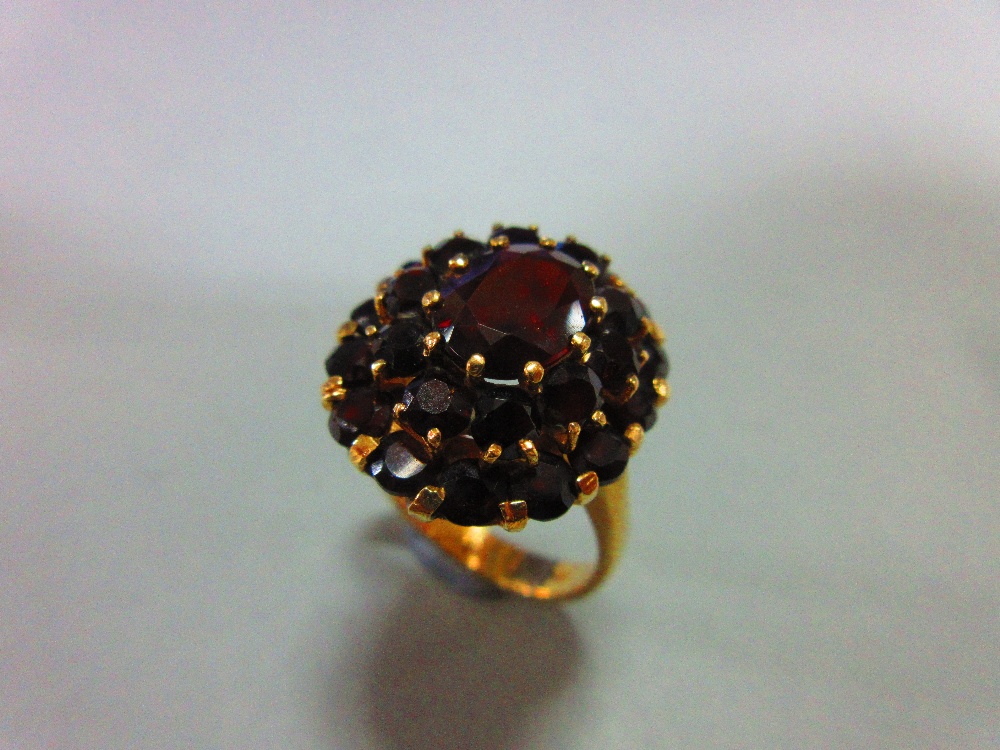 A Bohemian garnet cluster ring and a pair of matched earstuds, the ring with an oval cut pyrope - Image 2 of 4