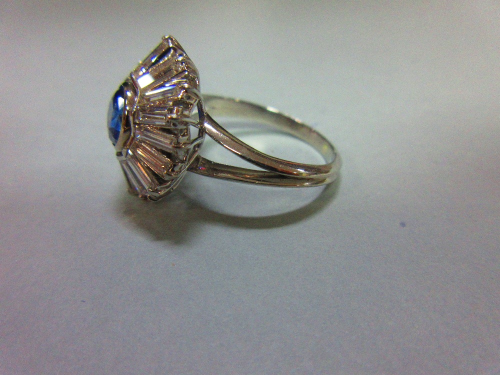 A sapphire and diamond sunburst cluster ring, the round cut light indigo coloured sapphire collet - Image 2 of 5