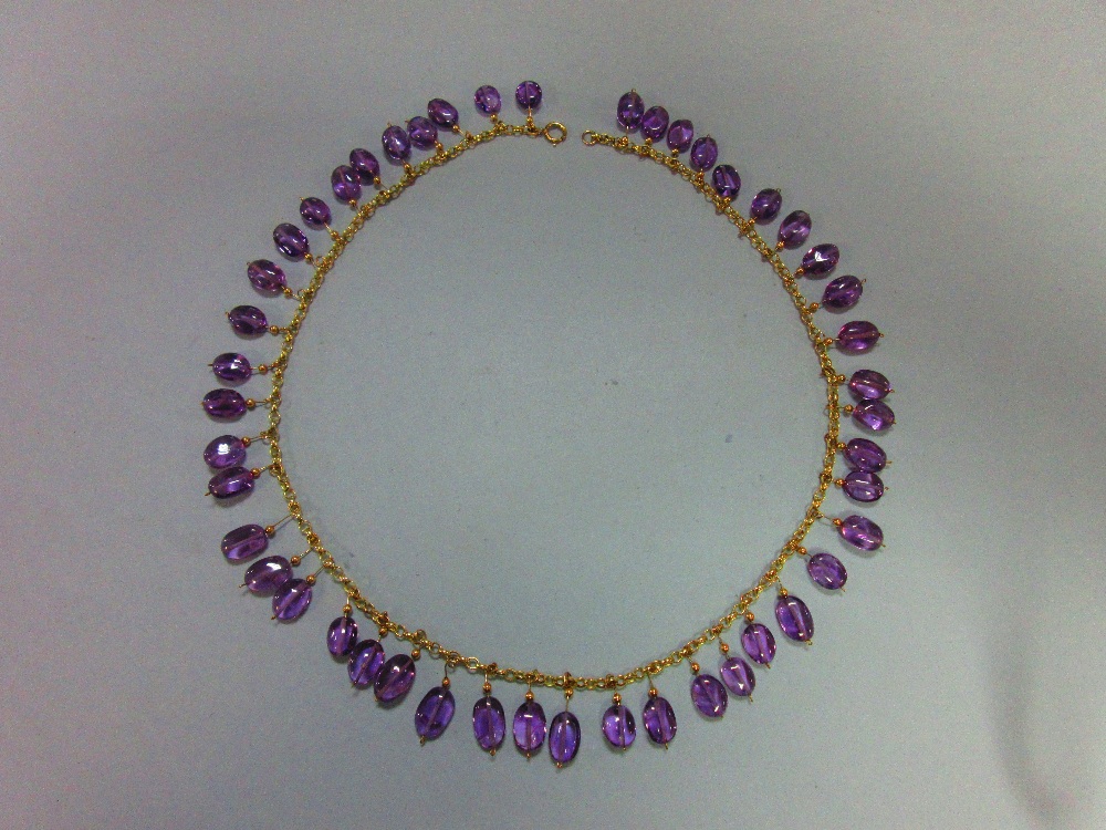 An amethyst fringe necklace, the unmarked yellow precious metal belcher link chain suspending evenly