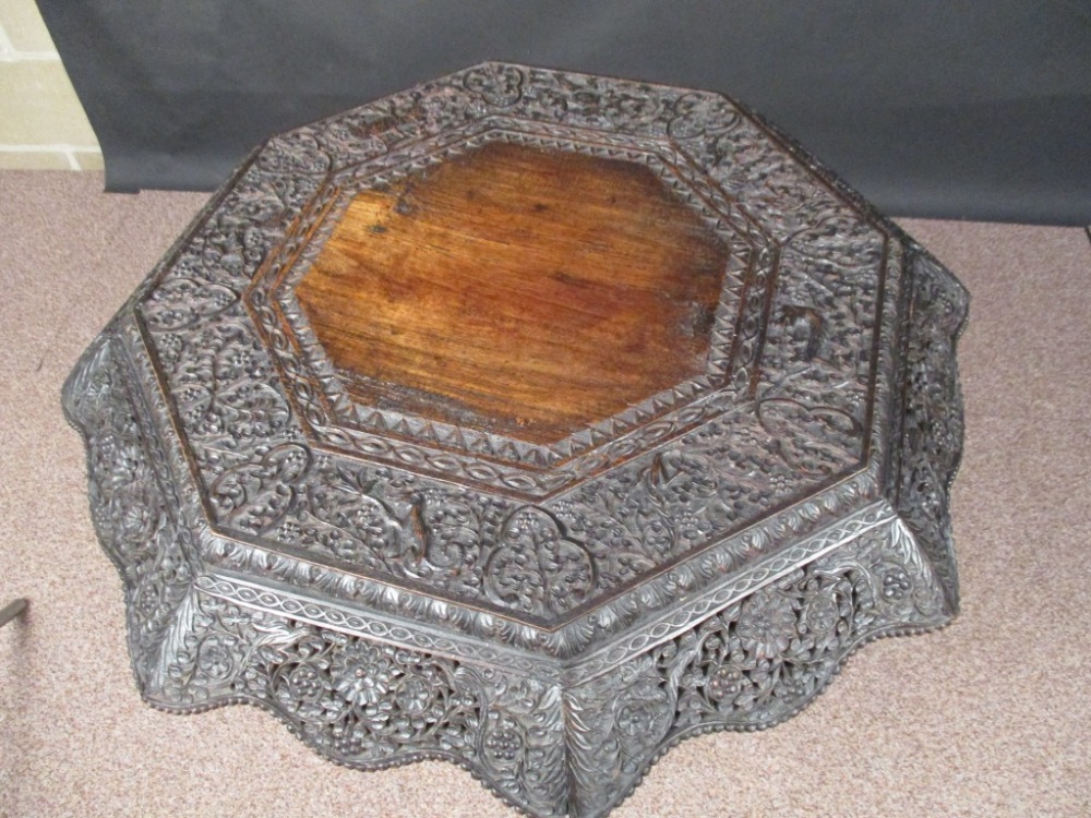 An Indian carved blackwood pedestal table, octagonal top decorated with birds and animals on a - Image 3 of 3