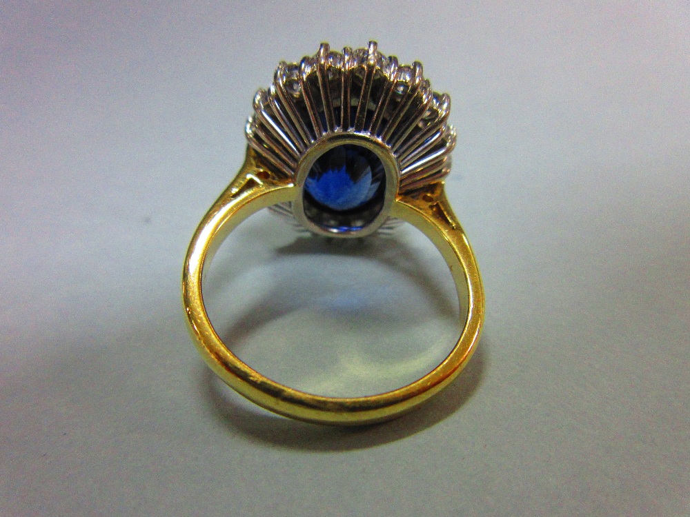 A large sapphire and diamond cluster ring, the oval cut deep blue sapphire, estimated weight 9. - Image 4 of 6