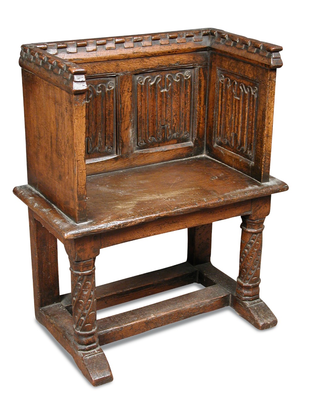 A Tudor revival oak pew seat, with castellated crest rail and linenfold panel back and sides, on