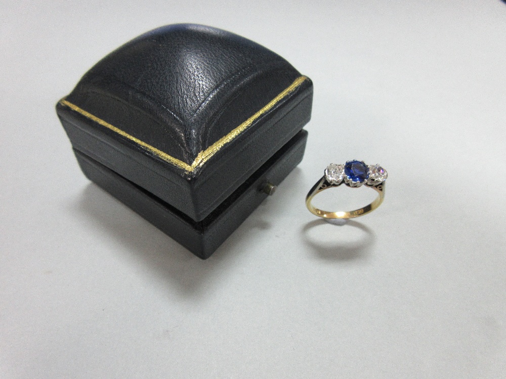 A three stone sapphire and diamond ring, claw set with a round cut royal blue sapphire between old - Image 6 of 7
