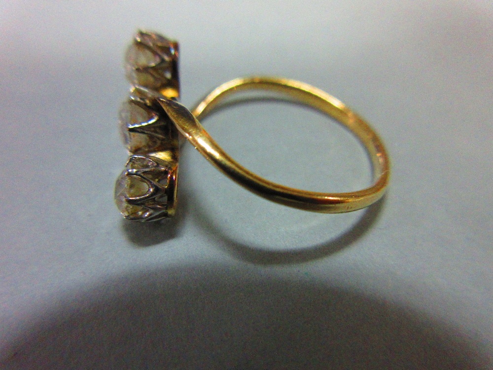 A three stone diamond ring, the three old cushion cut diamonds claw set in a diagonal line to a fine - Image 3 of 6