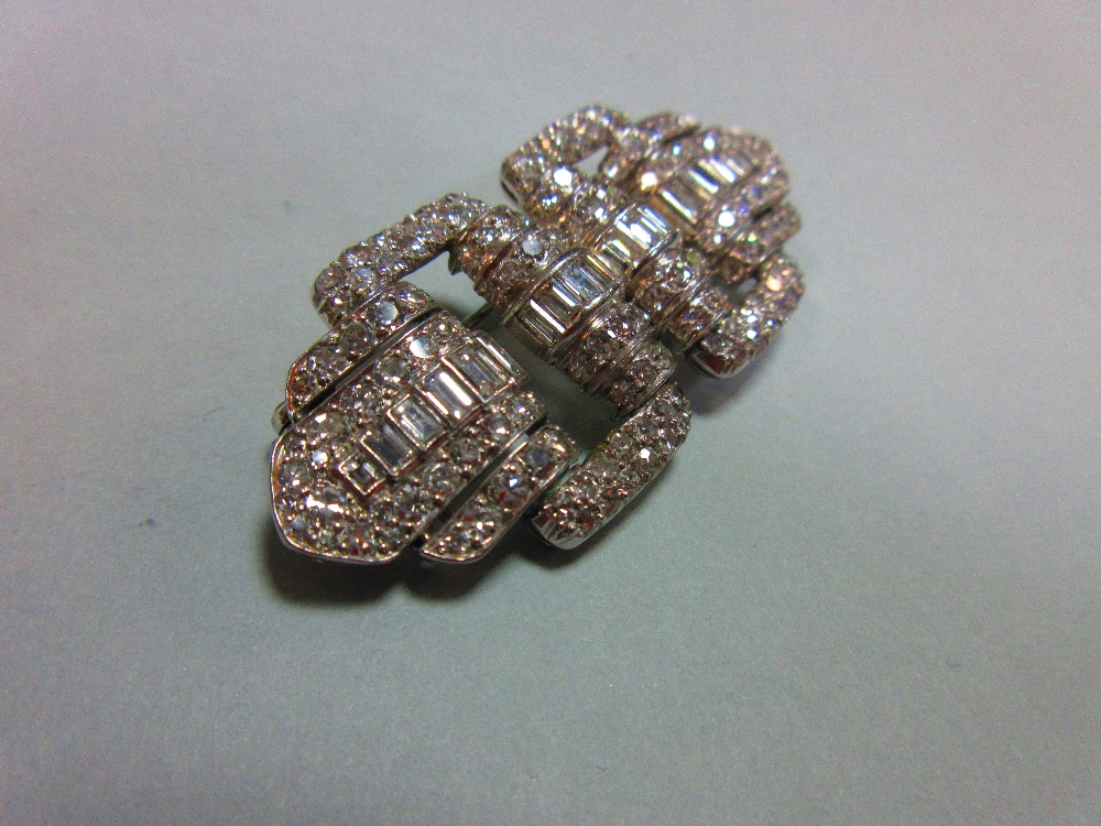 A French art deco odeonesque diamond and platinum brooch, of pierced double buckle form, with a - Image 4 of 6
