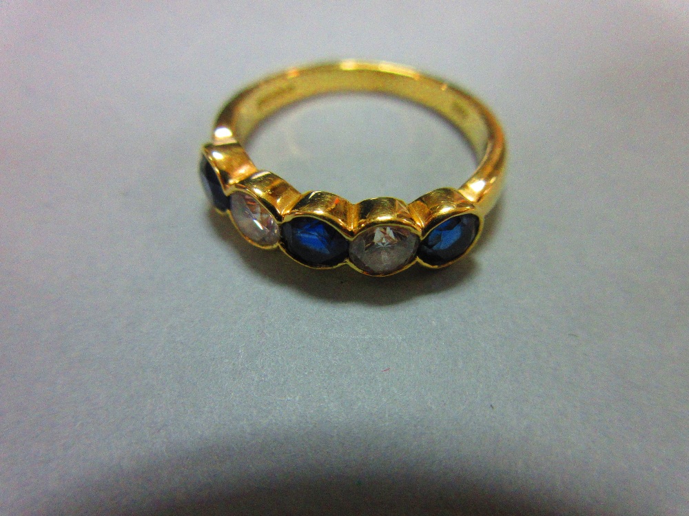 An 18ct gold, sapphire and diamond five stone ring, with two round brilliant cut diamonds spacing - Image 2 of 5