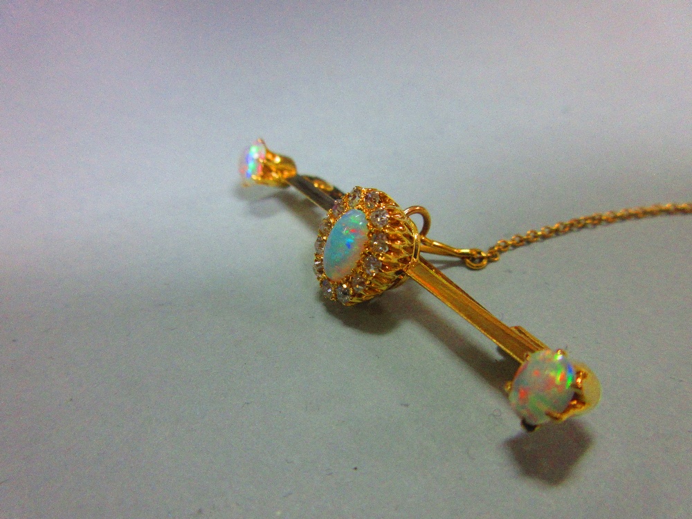An opal and diamond bar brooch, the knife edge bar set to the centre with an oval cabochon opal in a - Image 2 of 5