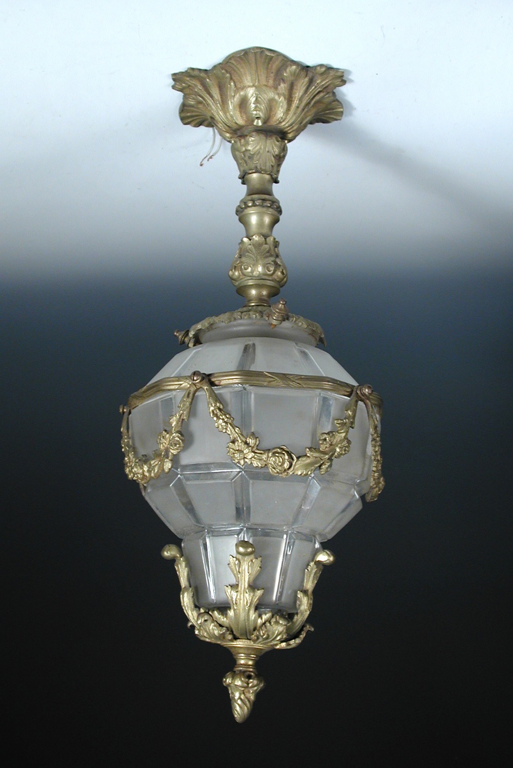 A modern brass mounted and frosted glass hall lantern, the pear shaped facetted glass shade