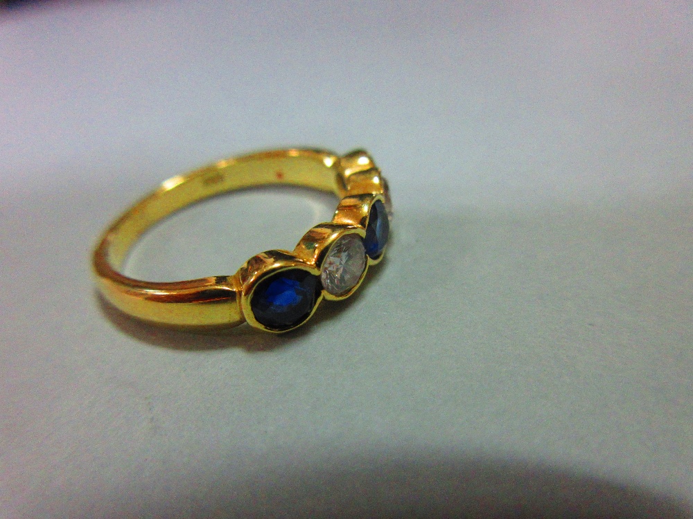 An 18ct gold, sapphire and diamond five stone ring, with two round brilliant cut diamonds spacing - Image 5 of 5