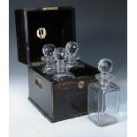 A 19th century calamander decanter box, the rising top opening to reveal four period cut glass