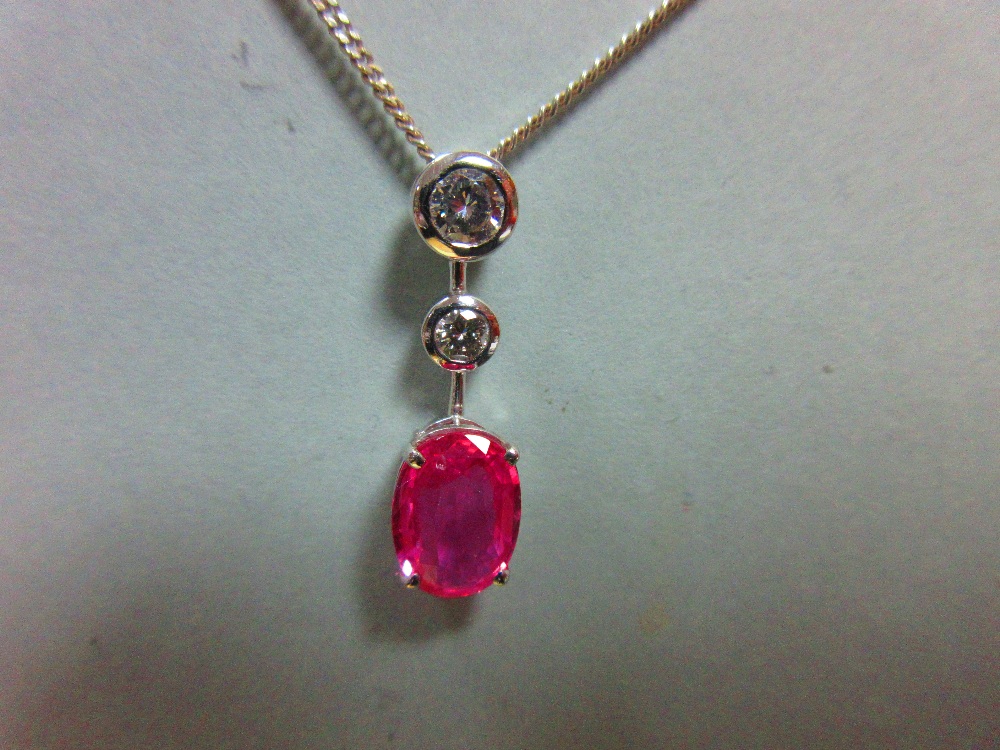 A pink sapphire and diamond pendant set in 18ct white gold, designed as a line of three stones - Image 2 of 6