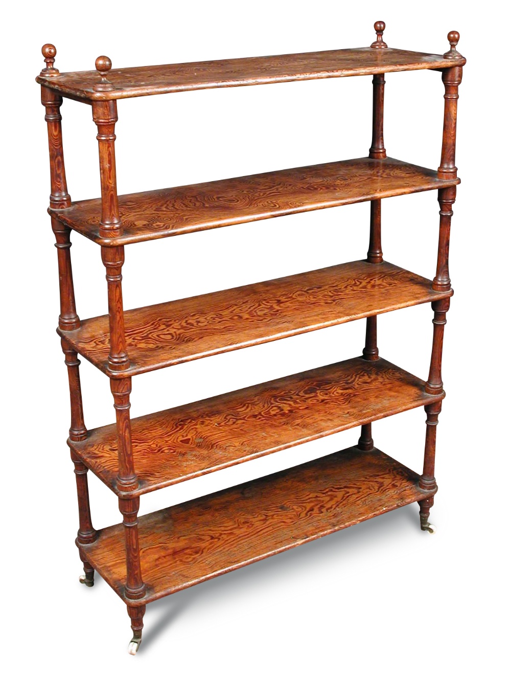 A late 19th century Oregon pine shelf, of five open tiers, with turned finials and on turned feet