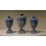 A garniture of three Wedgwood blue jasper vases and covers, each of the ovoid bodies sprigged with