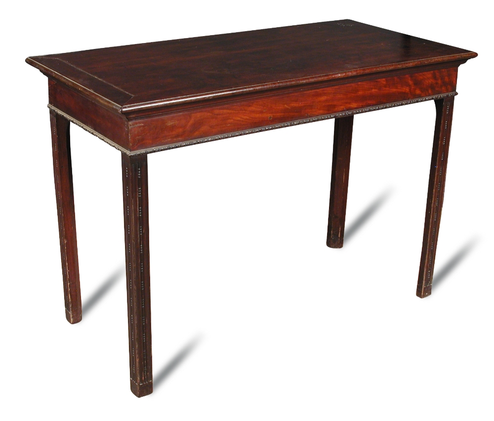 A small George III mahogany serving table, with later carved decoration, on chamfered square section