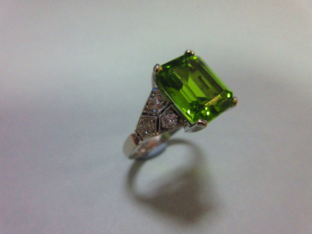 A 1930s style peridot and diamond ring, the emerald cut peridot measuring 10.6 x 8.7mm, four claw - Image 2 of 5