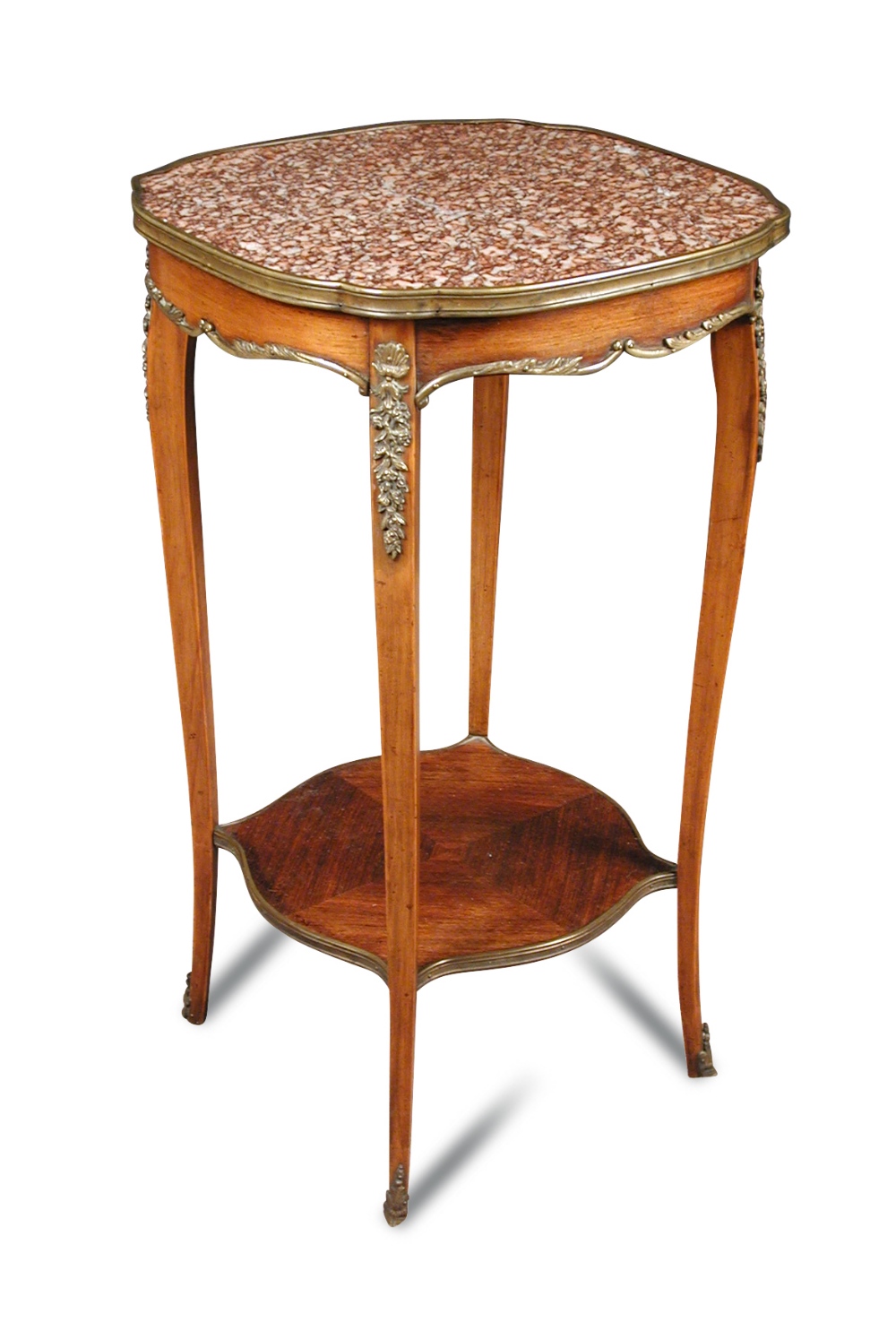 A Transitional style mahogany and rouge marble gueridon, the shaped top with gilt brass mounts