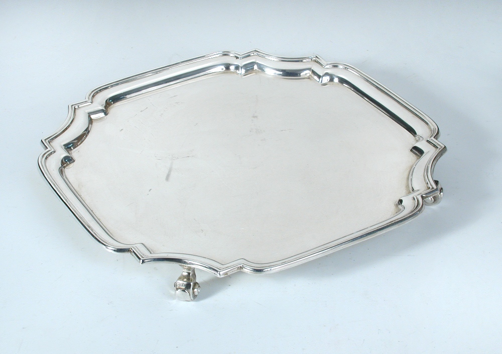 A silver salver, by the Adie Brothers, Birmingham 1939, square with shaped canted corners and