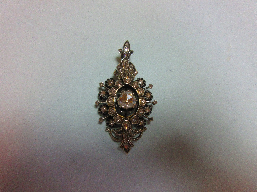 A late 19th or early 20th century diamond pendant with large central stone, of navette outline and