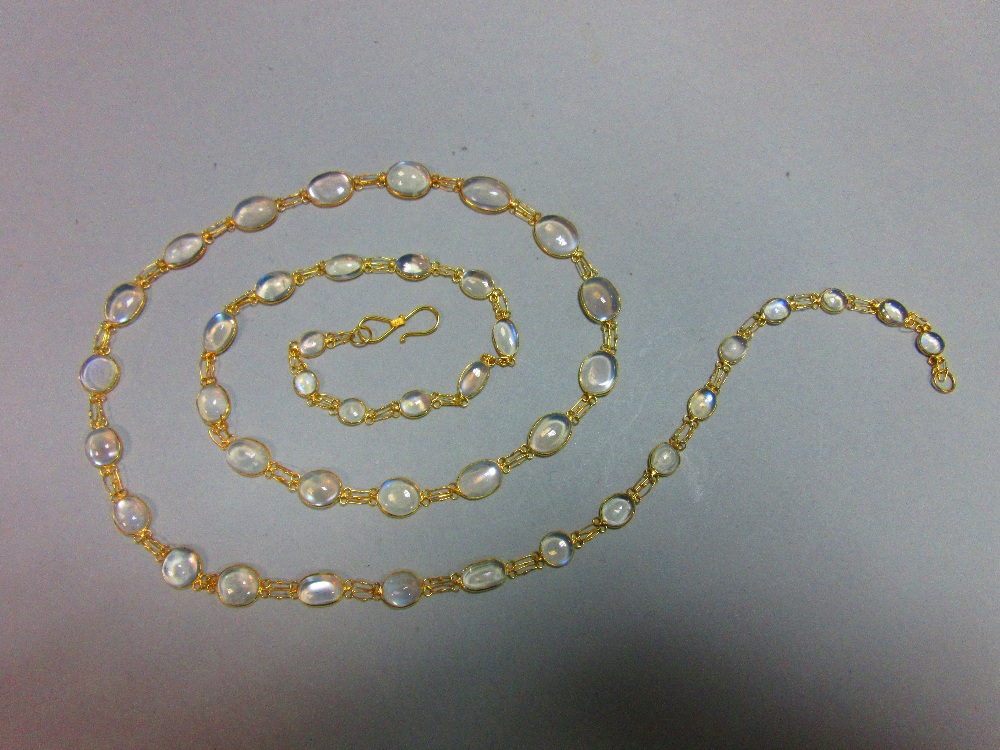 A moonstone necklace, designed as a chain of graduated spectacle set cabochon moonstones joined by